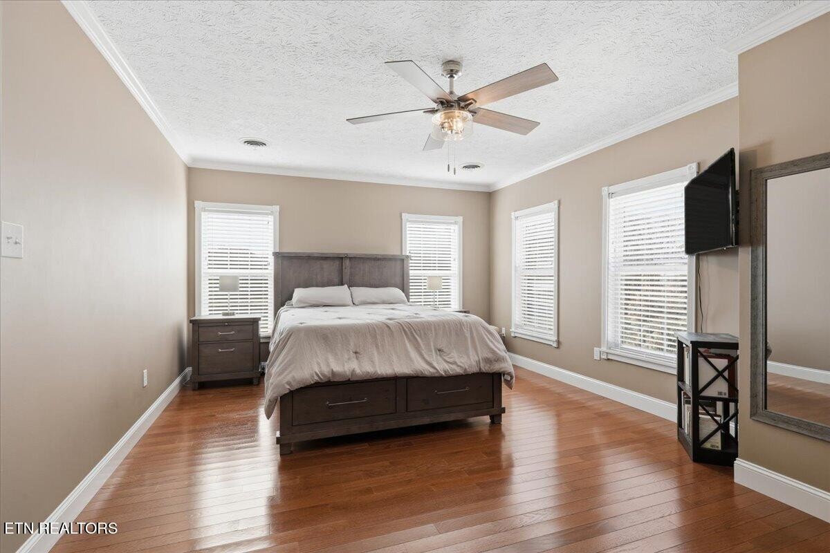 105 Carl Terry Road Wartburg, TN 37887 - Photo 24 of 55 a bedroom with a bed a dresser and wooden floor