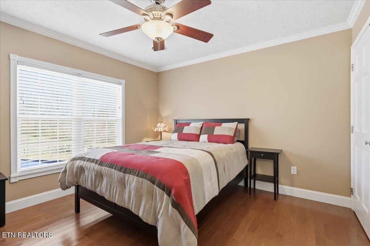 105 Carl Terry Road Wartburg, TN 37887 - Photo 30 of 55 a bedroom with a bed and a chandelier