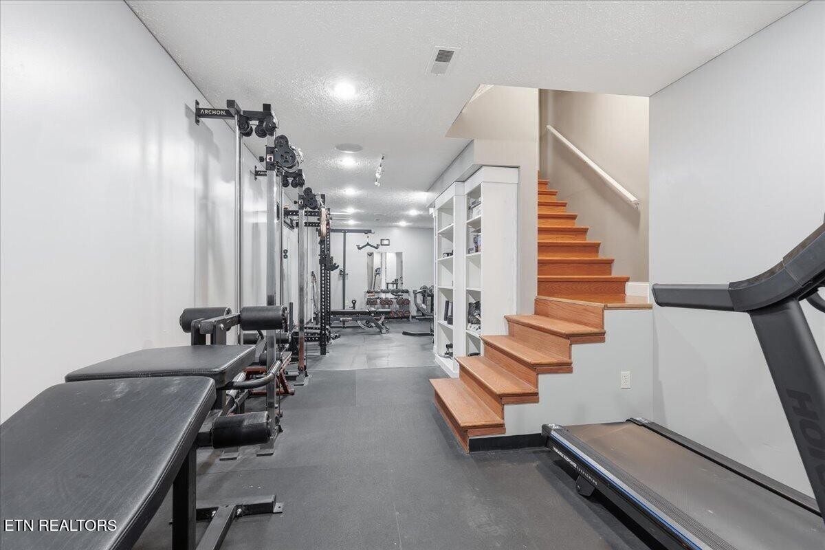 105 Carl Terry Road Wartburg, TN 37887 - Photo 33 of 55 a room with gym equipment and lots of mirrors