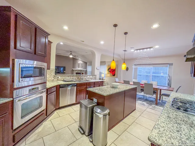 a bathroom with a granite countertop shower and a sink