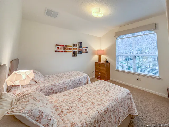 a bedroom with bed and a night stand