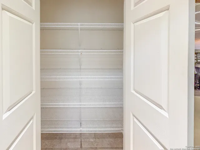 a spacious bedroom with a bed and a flat screen tv