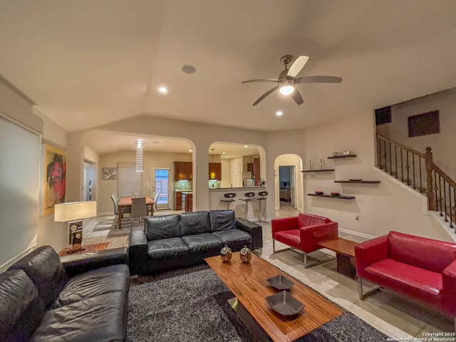 a living room with furniture and a chandelier
