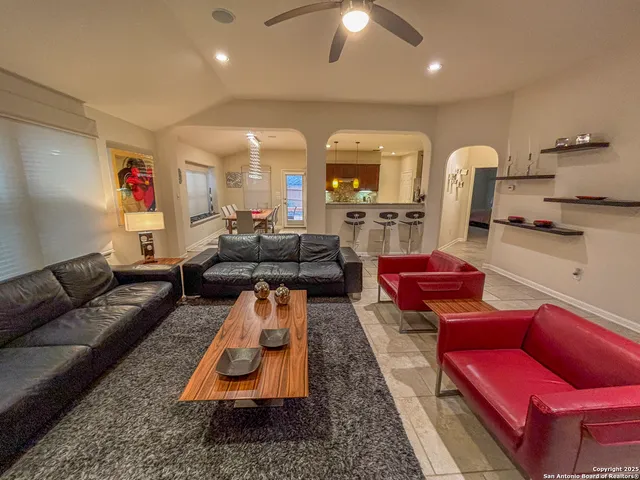 a living room with furniture and a chandelier