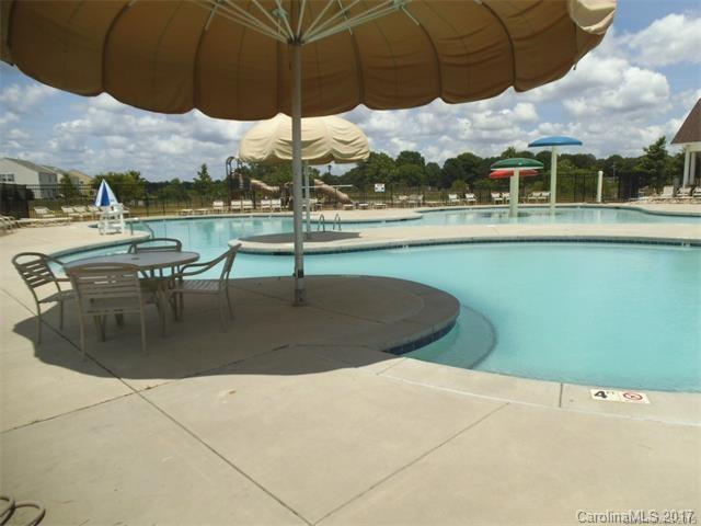 1006 Green Terra Road Indian Trail, NC 28079 - Photo 11 of 11 a view of a swimming pool with a table and chairs under an umbrella
