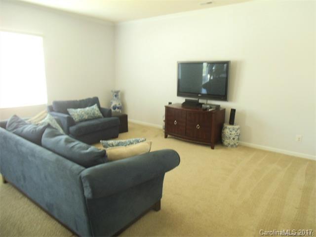 1006 Green Terra Road Indian Trail, NC 28079 - Photo 5 of 11 a living room with furniture and a flat screen tv