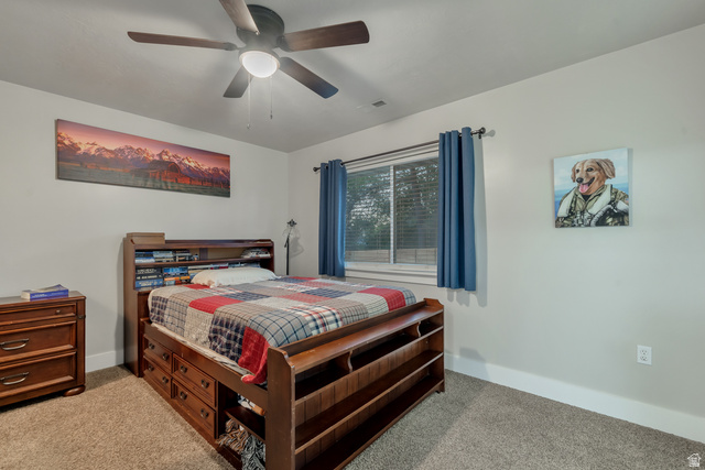 Undisclosed Address Ogden, UT 84403 - Photo 16 of 21 Bedroom with light colored carpet and a ceiling fan