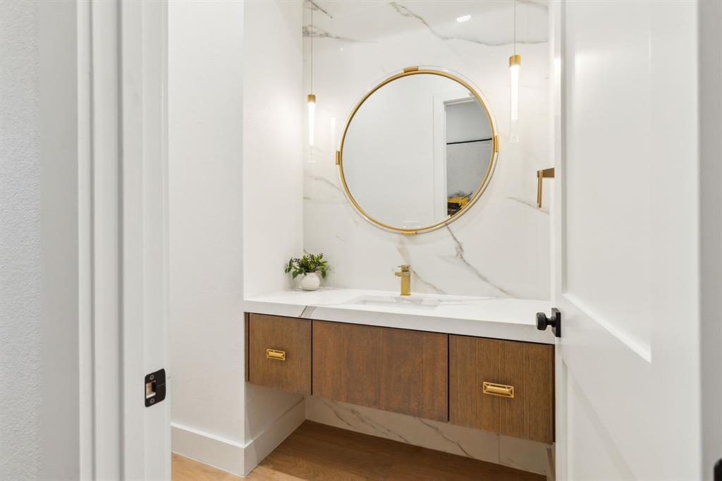 4311 Merrell Road Dallas, TX 75229 - Photo 17 of 30 a bathroom with a sink and a mirror