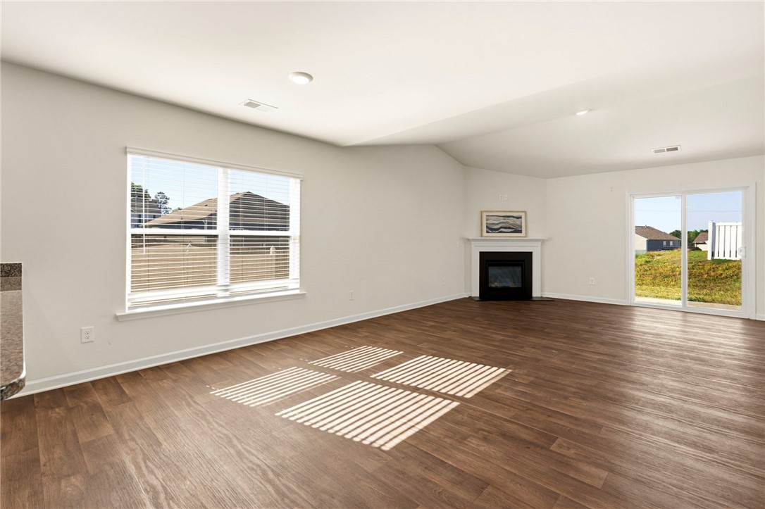 205 Hillendale Way Pelzer, SC 29669 - Photo 6 of 29 Bright and airy great room with a cozy fireplace and convenient sliding glass doors.