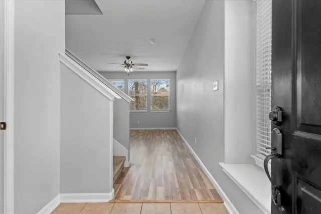 a view of a hallway view with wooden floor and staircase