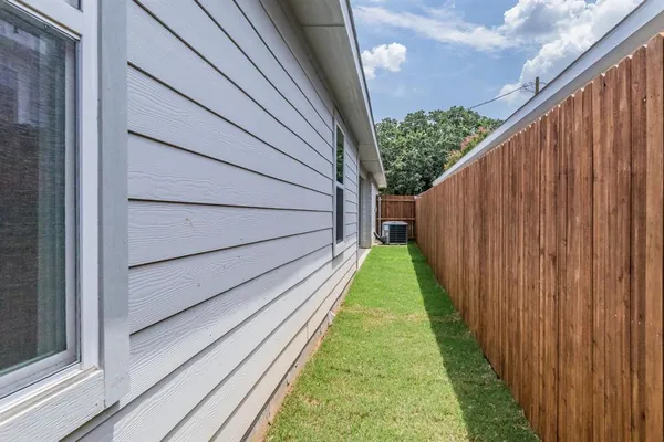 a view of a backyard with wooden fence