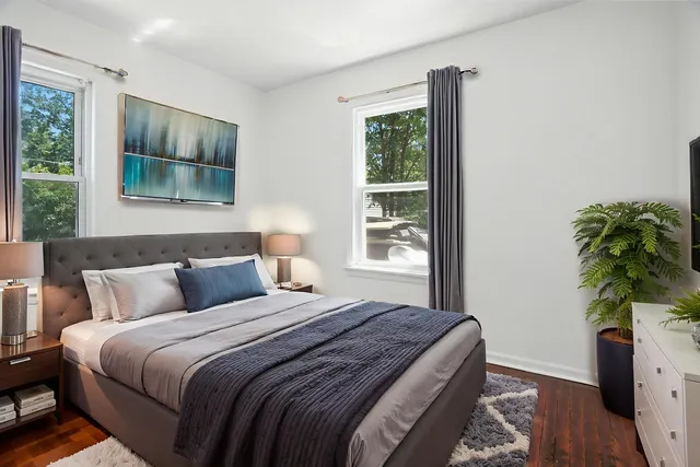 a bedroom with bed and a potted plant