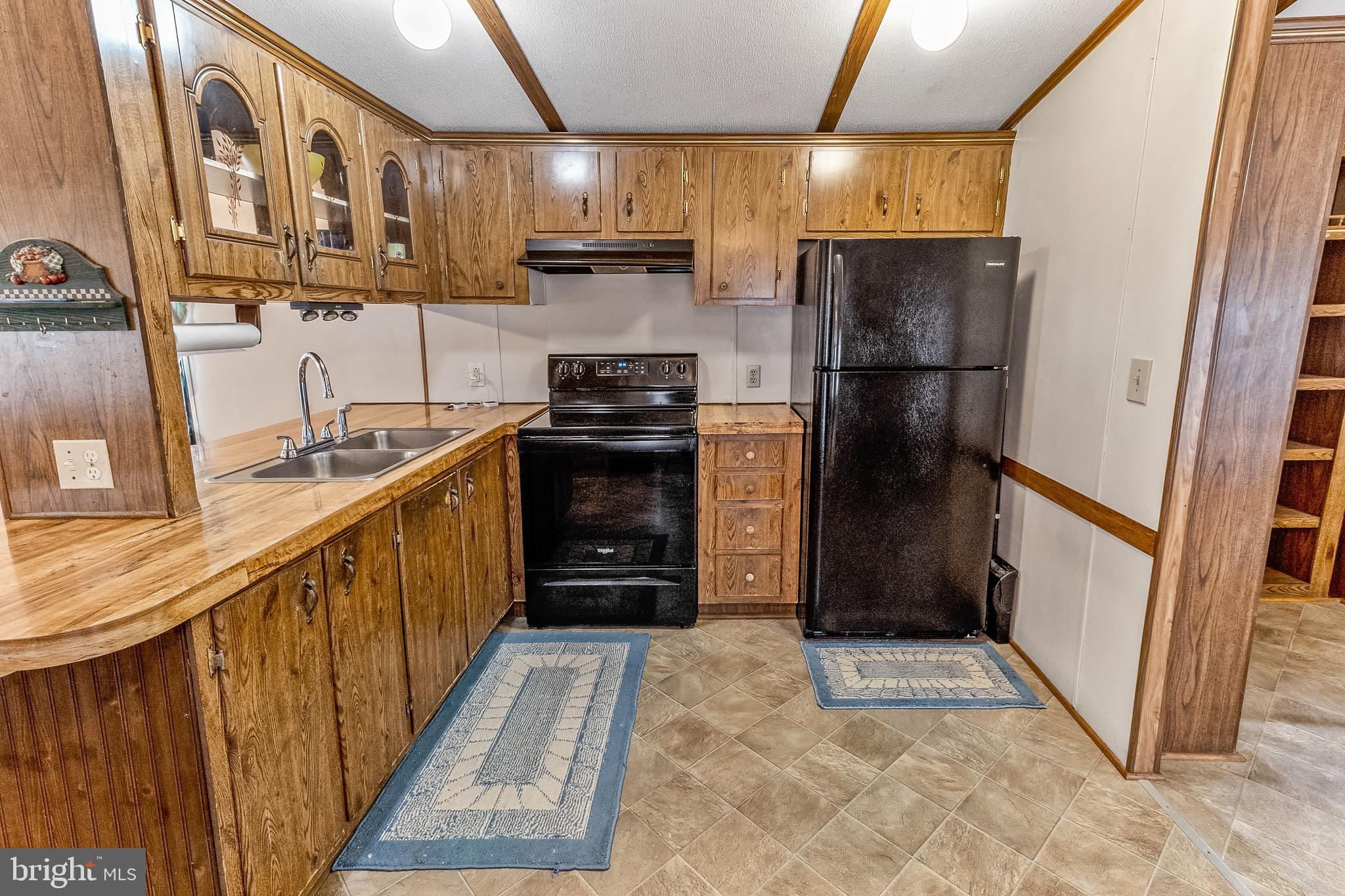 87 Explorer Lane Martinsburg, WV 25404 - Photo 11 of 27 a kitchen with stainless steel appliances granite countertop a refrigerator a stove and a sink with wooden floors