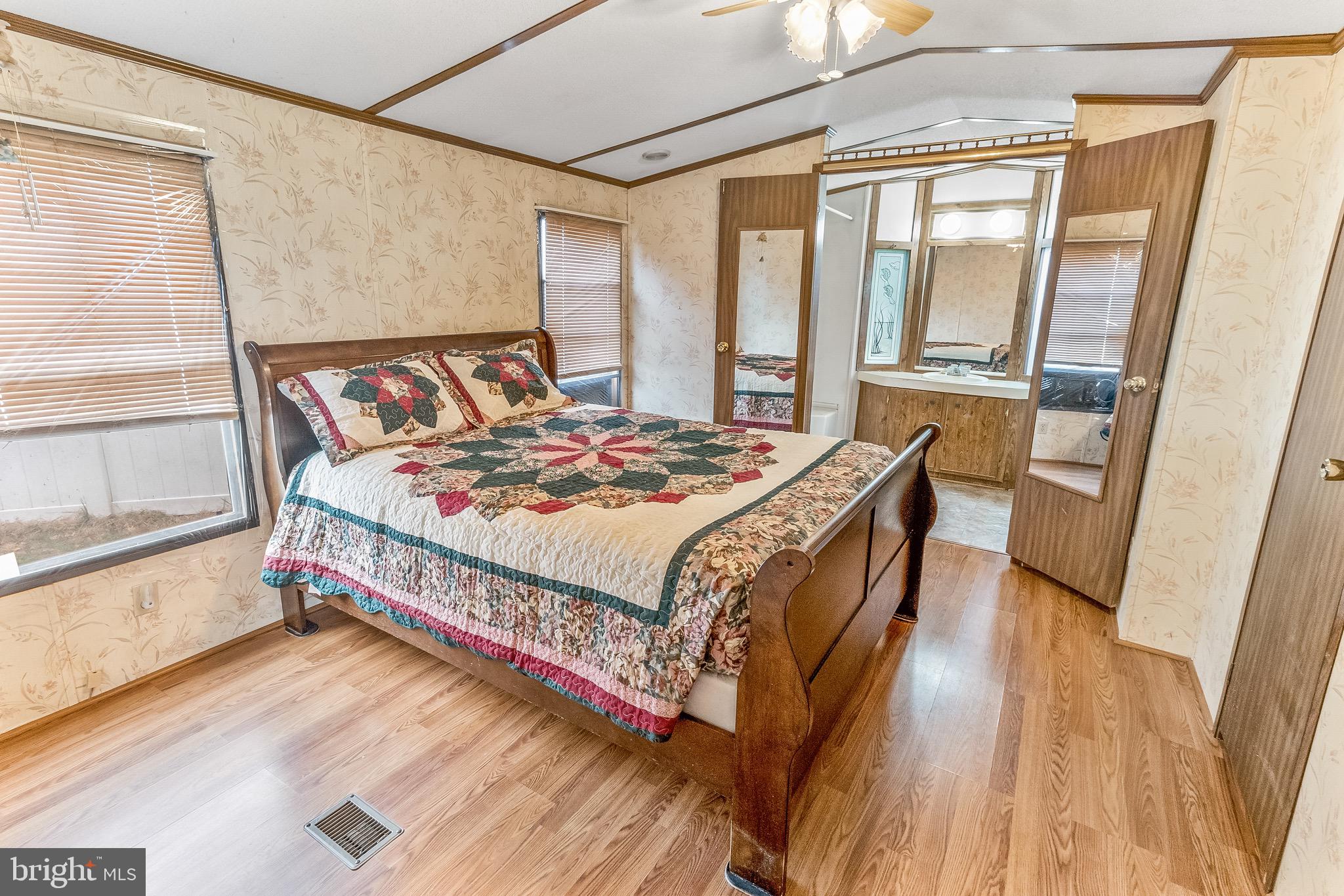 87 Explorer Lane Martinsburg, WV 25404 - Photo 15 of 27 a bedroom with a bed and a large window with wooden floor