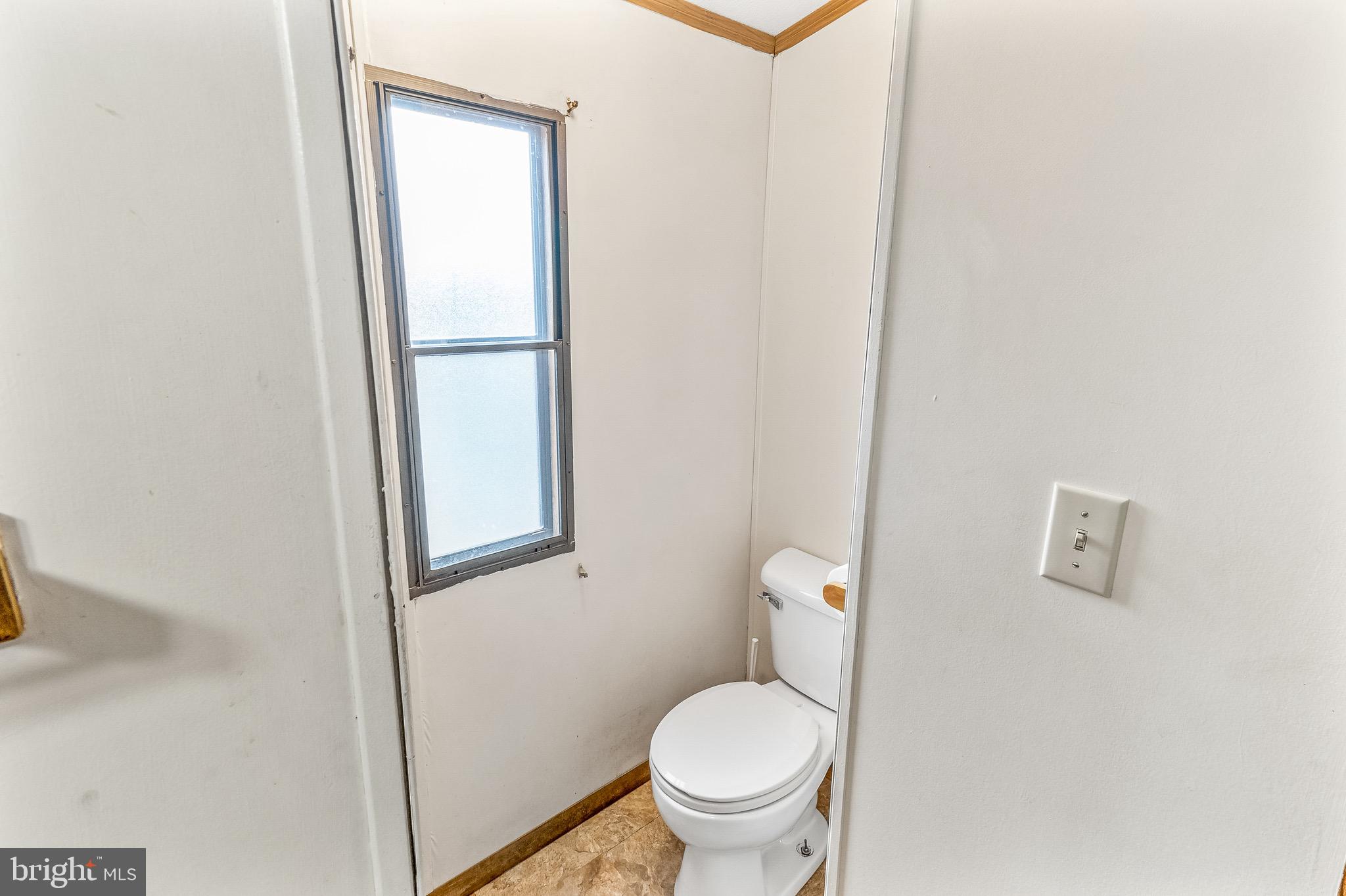 87 Explorer Lane Martinsburg, WV 25404 - Photo 18 of 27 a white toilet sitting next to a shower