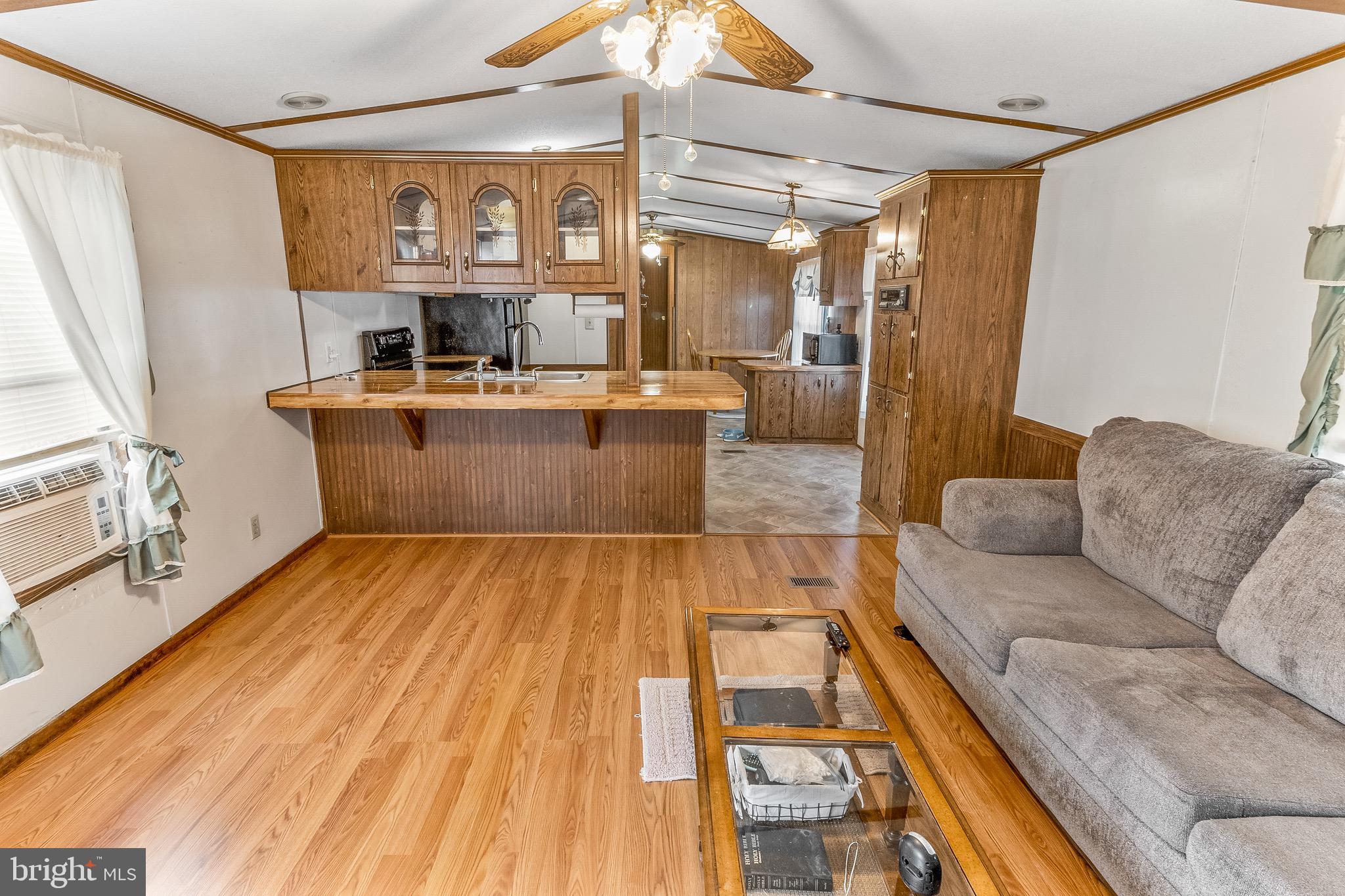 87 Explorer Lane Martinsburg, WV 25404 - Photo 7 of 27 a living room with a couch and a chandelier