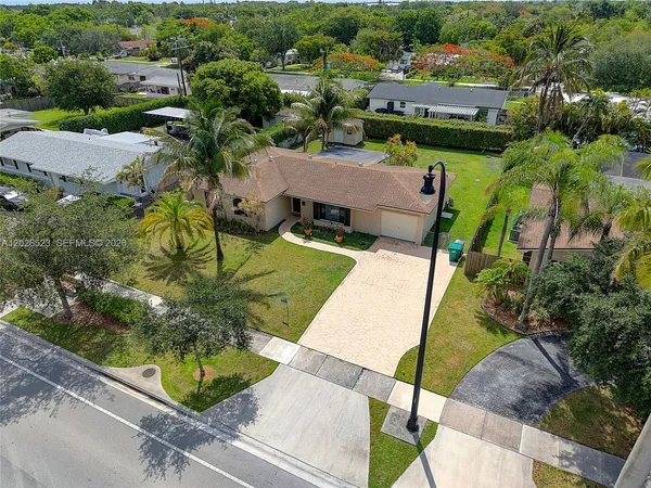 an aerial view of a house with garden space and street view
