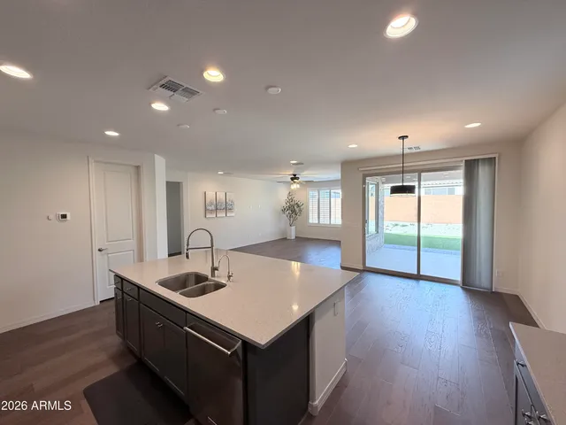 a kitchen with counter top space and windows