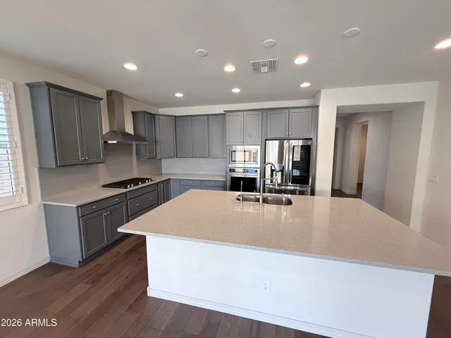 a large kitchen with stainless steel appliances lots of counter top space