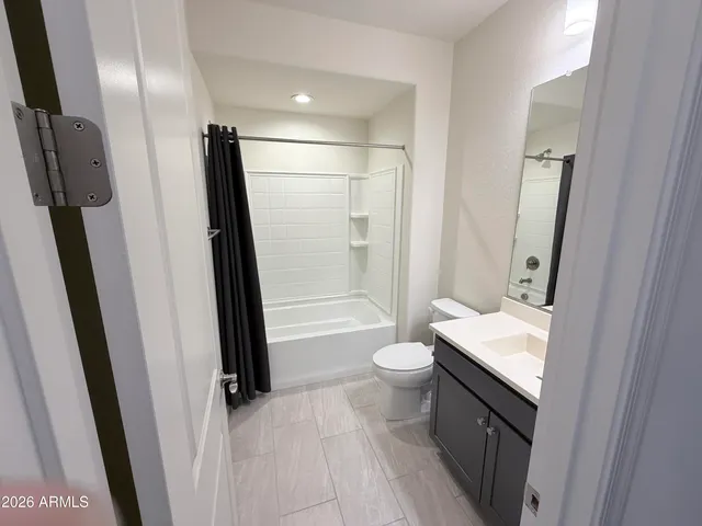 a bathroom with a sink a toilet a tub and shower