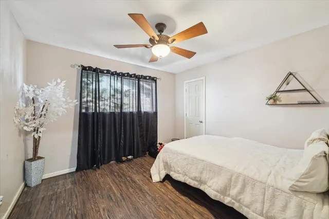 a bedroom with a large bed and a chandelier