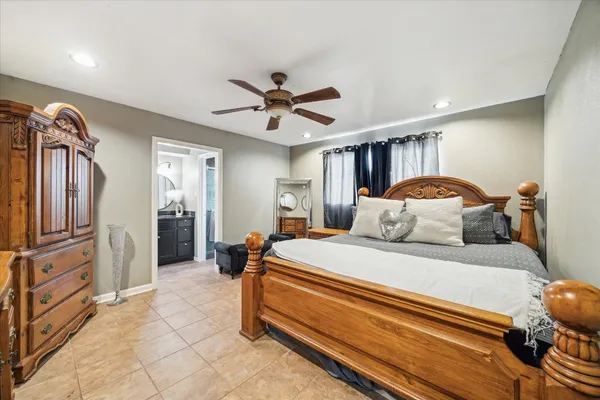 a spacious bedroom with a bed and a chandelier
