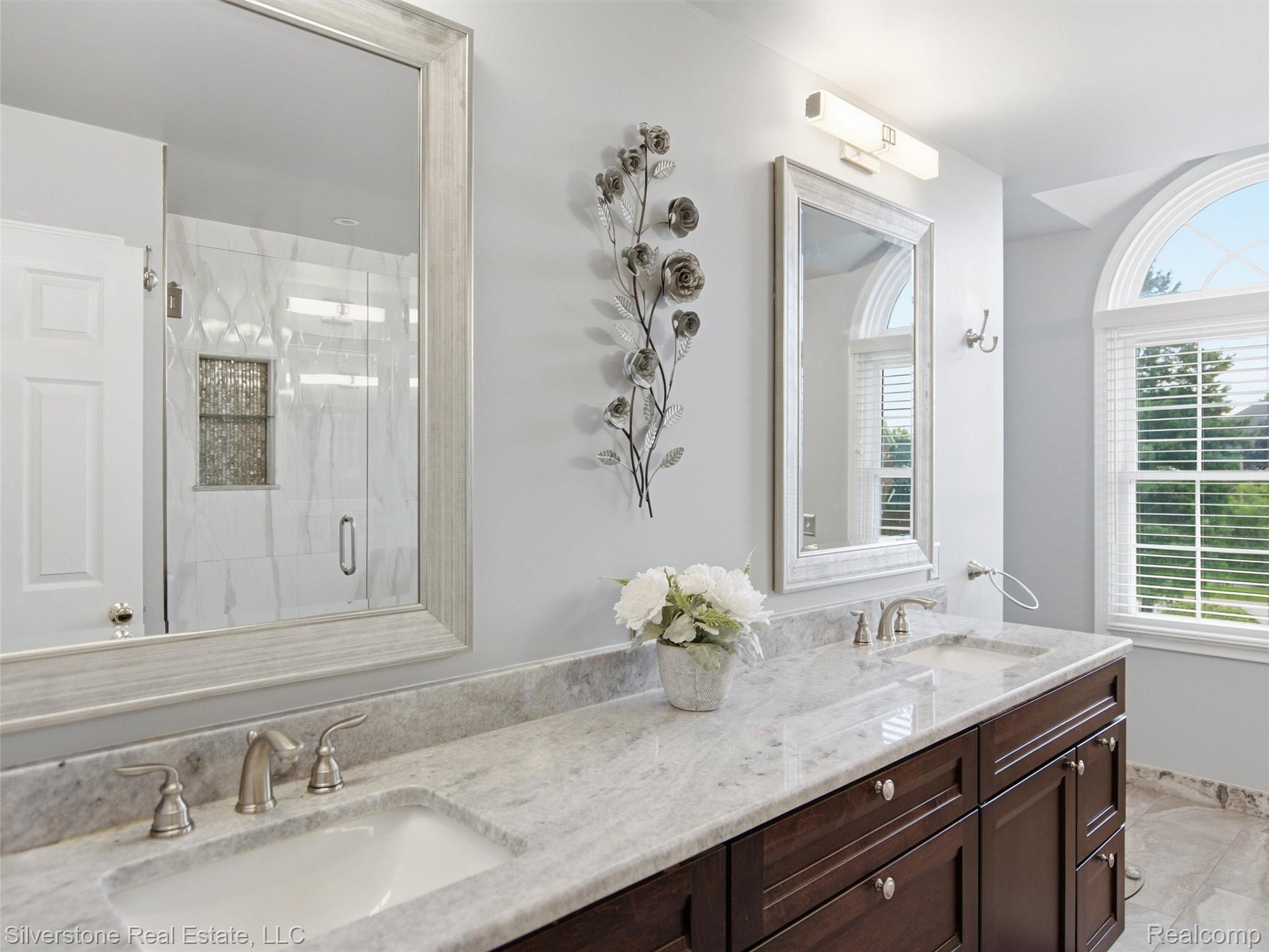6577 Edith Court Troy, MI 48085 - Photo 38 of 61 Dual vanity featuring a light-toned countertop, undermount sinks, and brushed nickel fixtures