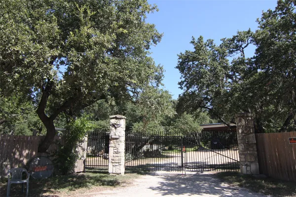 a sign board with yard in the back