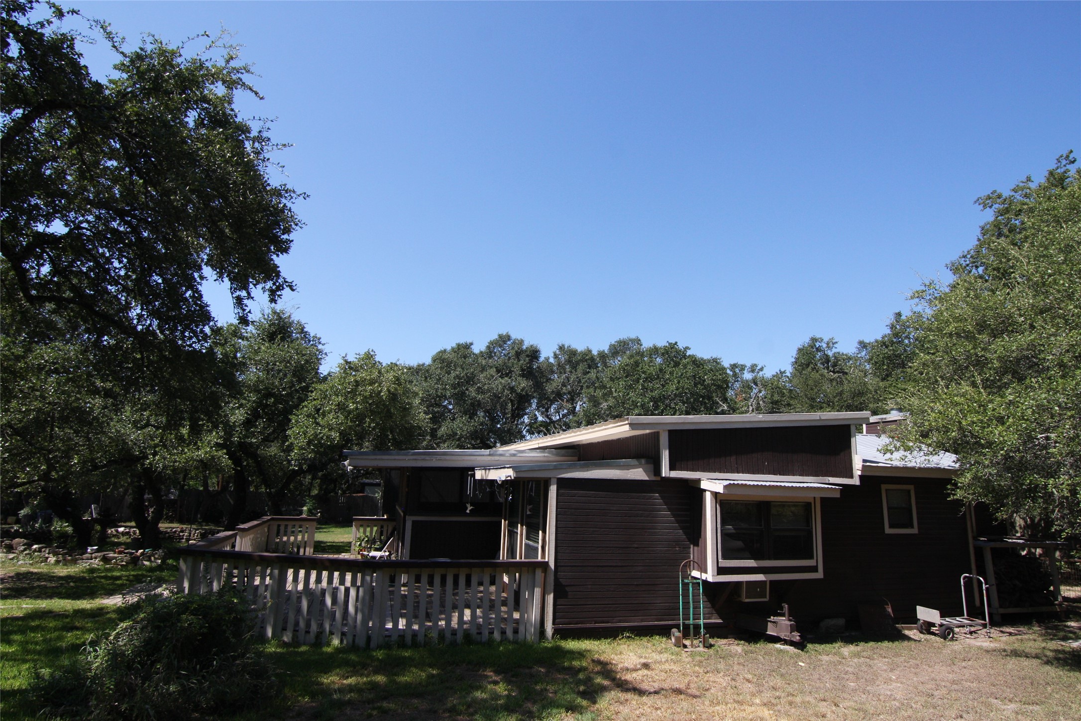 7806-7804 Indian Ridge Drive Austin, TX 78737 - Photo 11 of 40 a front view of a house with a yard