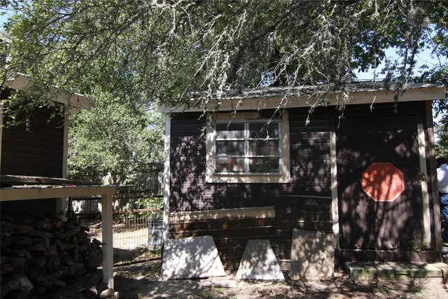 a view of a backyard with table and chairs and a tree