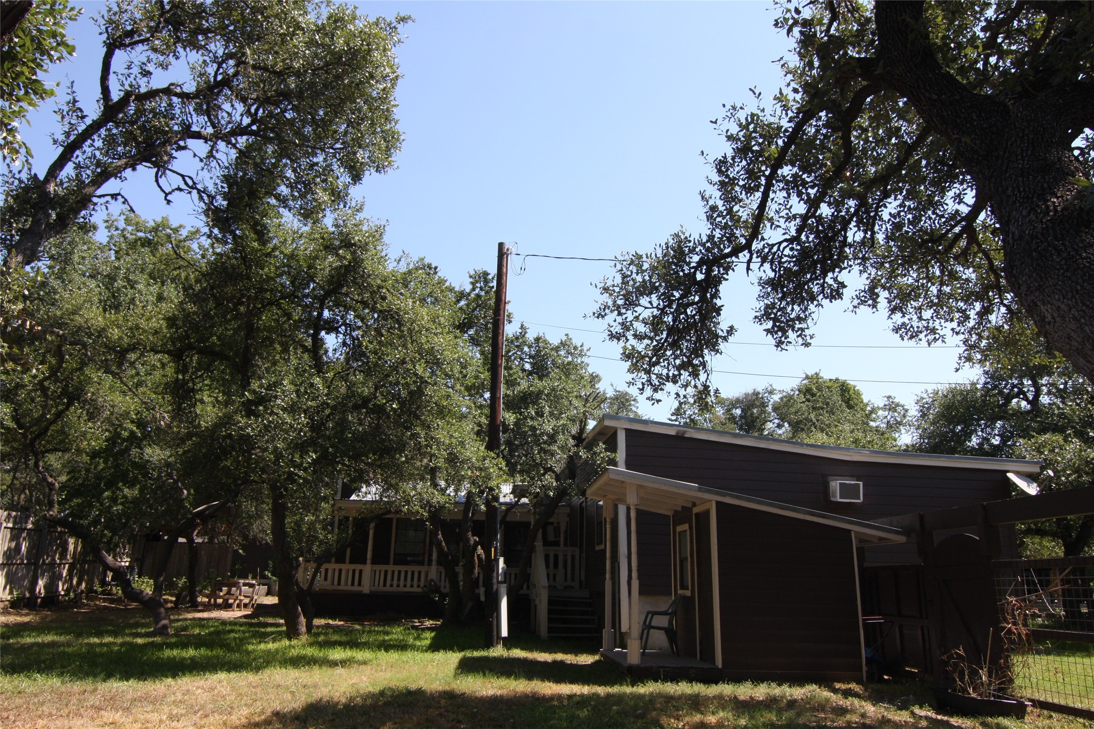 7806-7804 Indian Ridge Drive Austin, TX 78737 - Photo 20 of 40 a view of a house with a yard