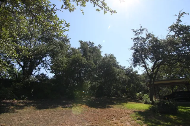 a view of a patio with table and chairs and potted plants