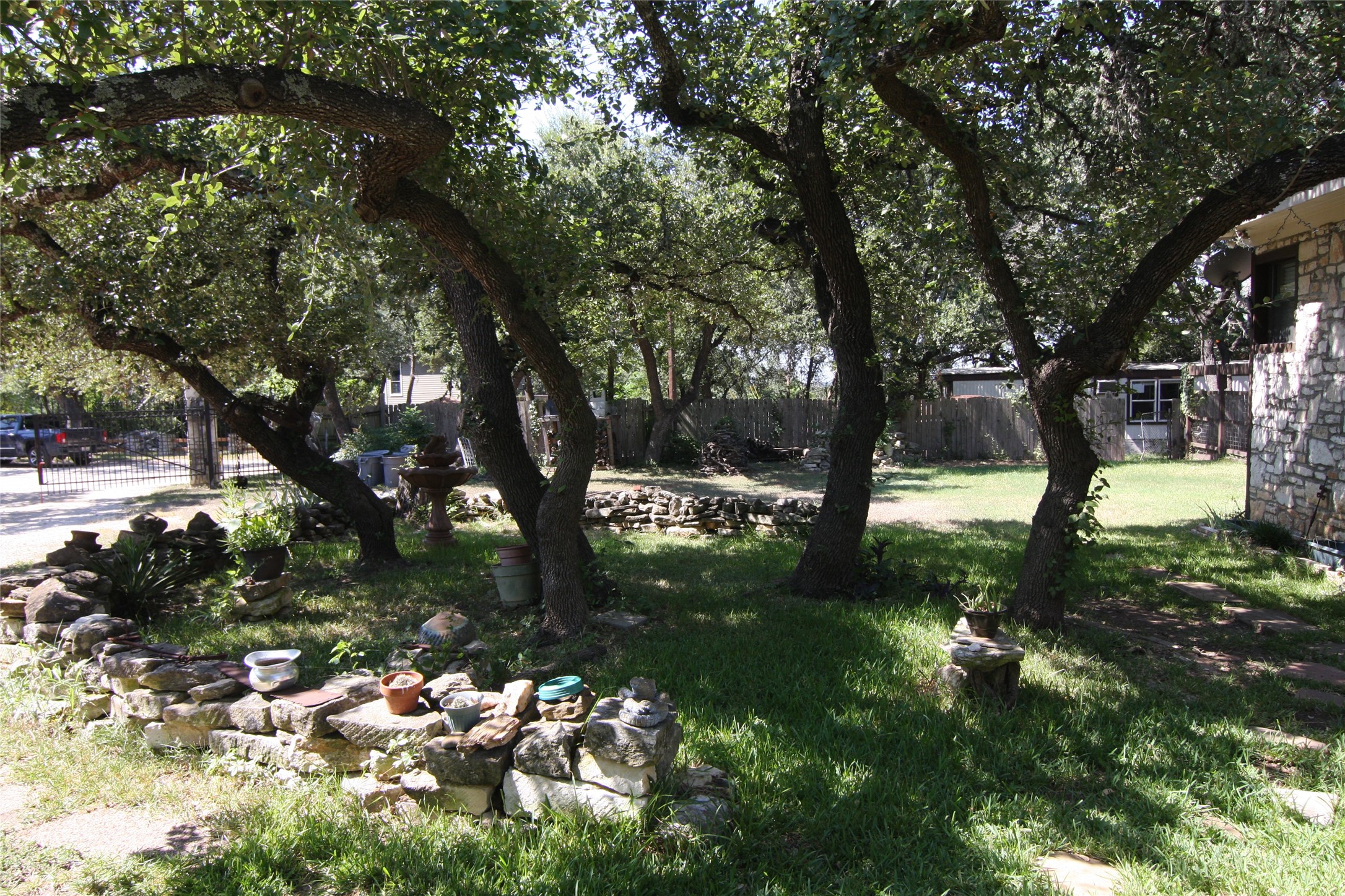 7806-7804 Indian Ridge Drive Austin, TX 78737 - Photo 24 of 40 a view of a tree in the middle of a yard
