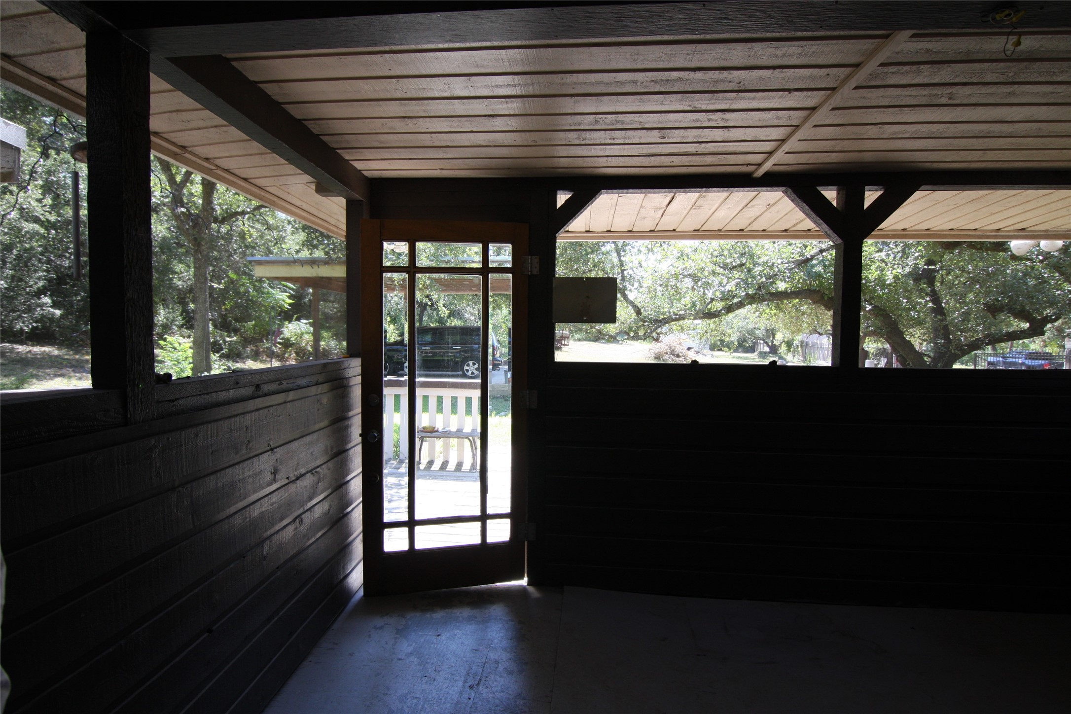 7806-7804 Indian Ridge Drive Austin, TX 78737 - Photo 26 of 40 a view of empty room with wooden floor and a floor to ceiling window