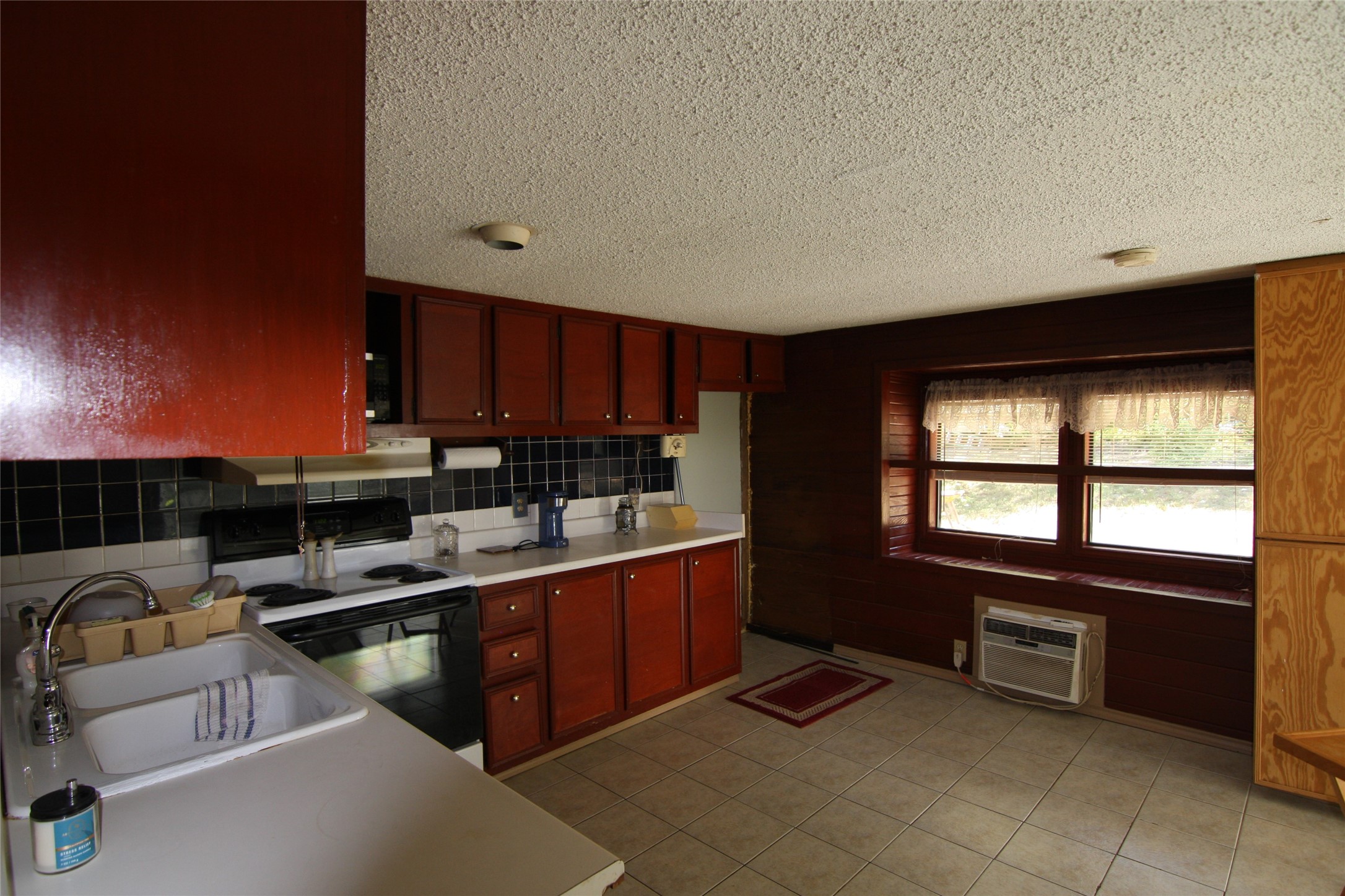 7806-7804 Indian Ridge Drive Austin, TX 78737 - Photo 28 of 40 a kitchen with stainless steel appliances granite countertop a sink dishwasher stove and cabinets
