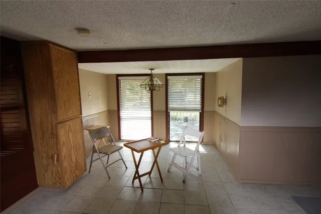 a view of a livingroom with a ceiling fan and window