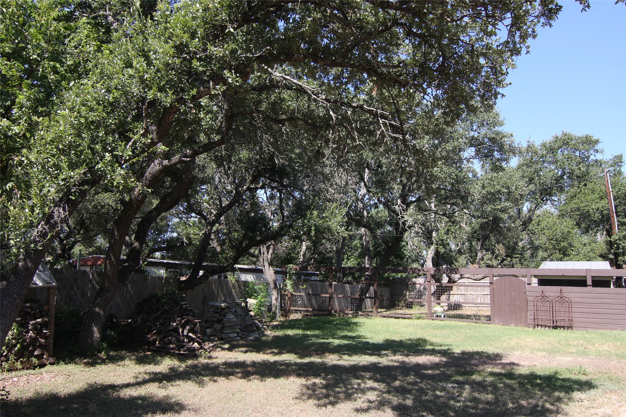 7806-7804 Indian Ridge Drive Austin, TX 78737 - Photo 3 of 40 a view of a chairs and fire pit in the middle of a yard
