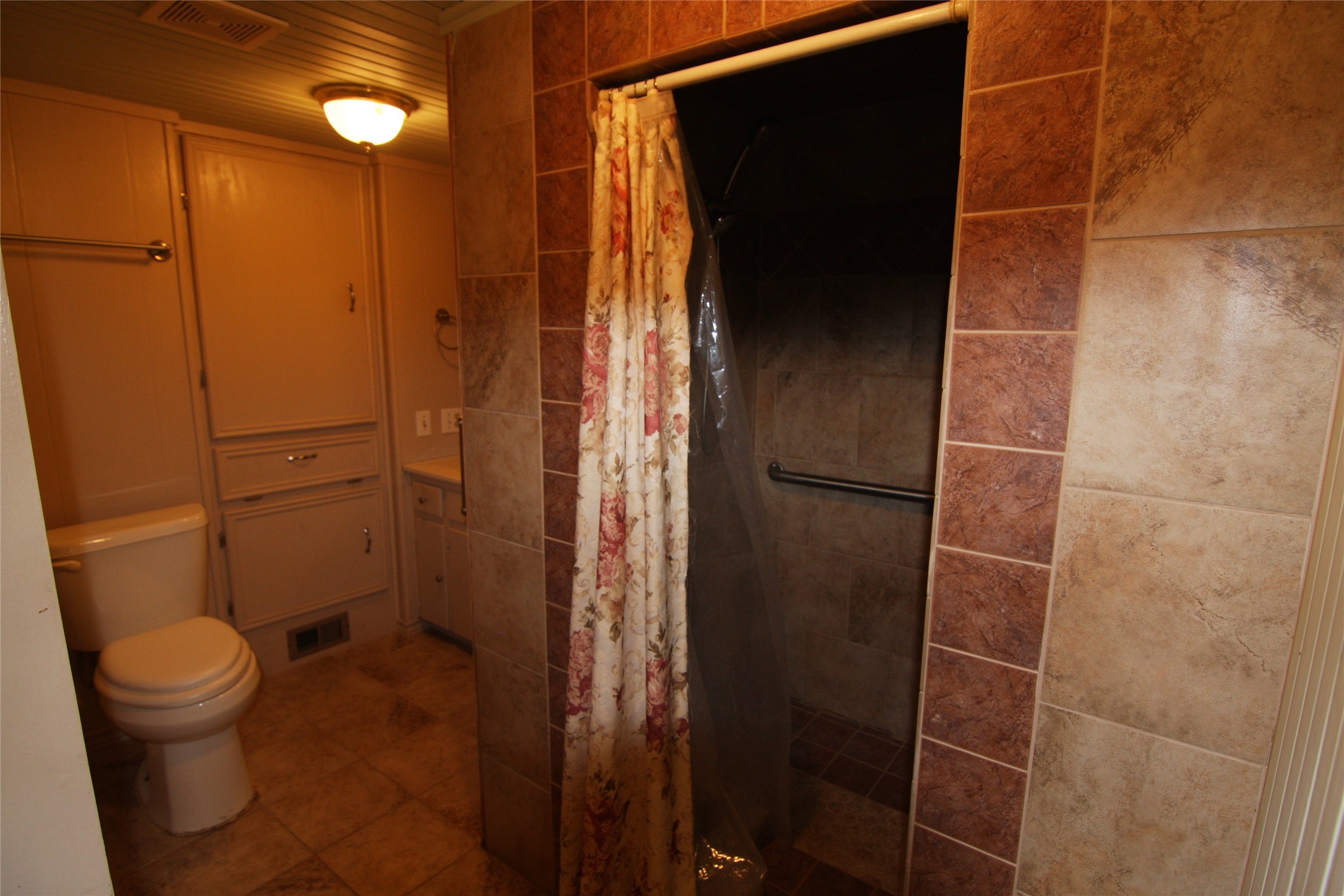 7806-7804 Indian Ridge Drive Austin, TX 78737 - Photo 36 of 40 a bathroom with a toilet and a shower