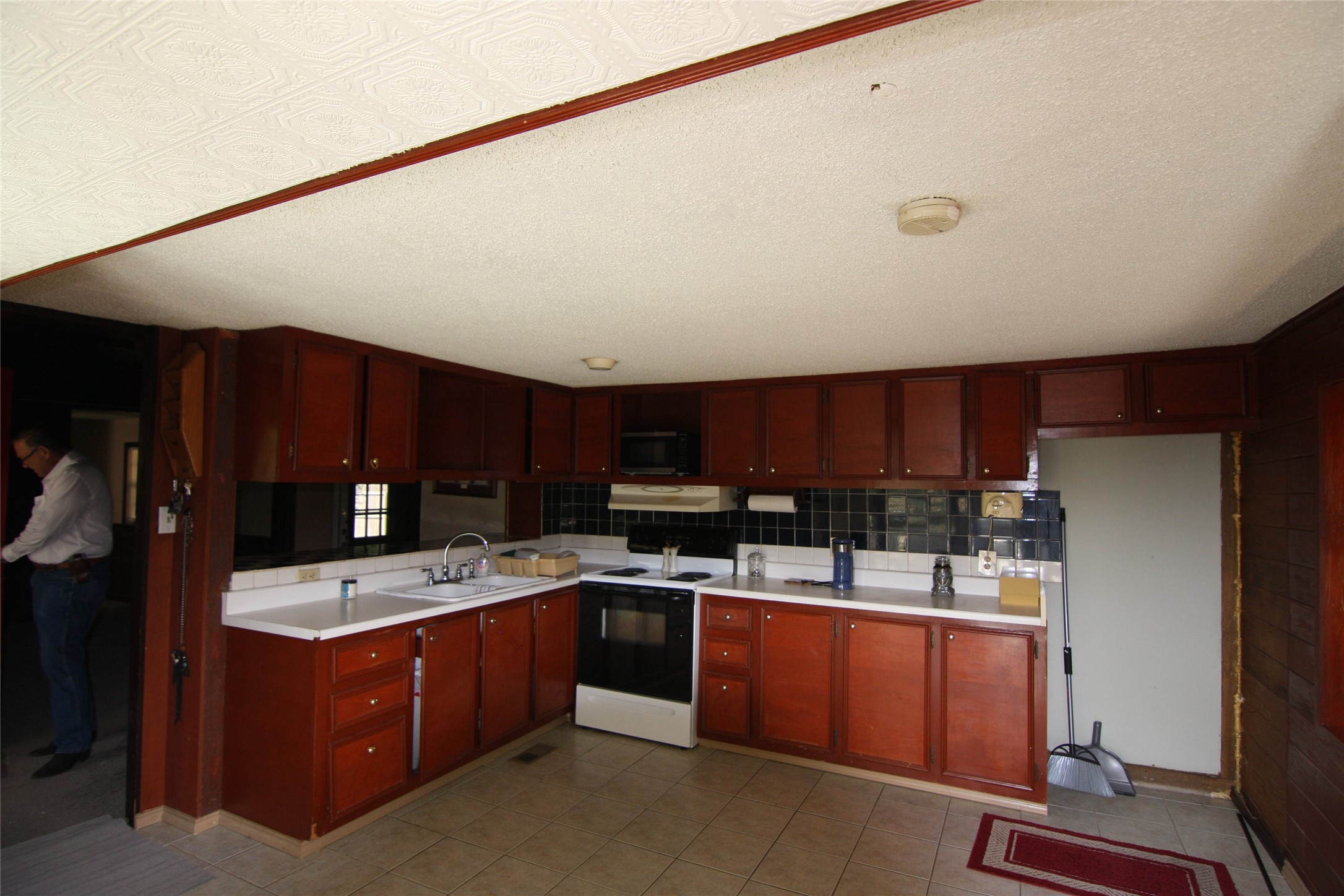 7806-7804 Indian Ridge Drive Austin, TX 78737 - Photo 37 of 40 a kitchen with a sink a stove and cabinets