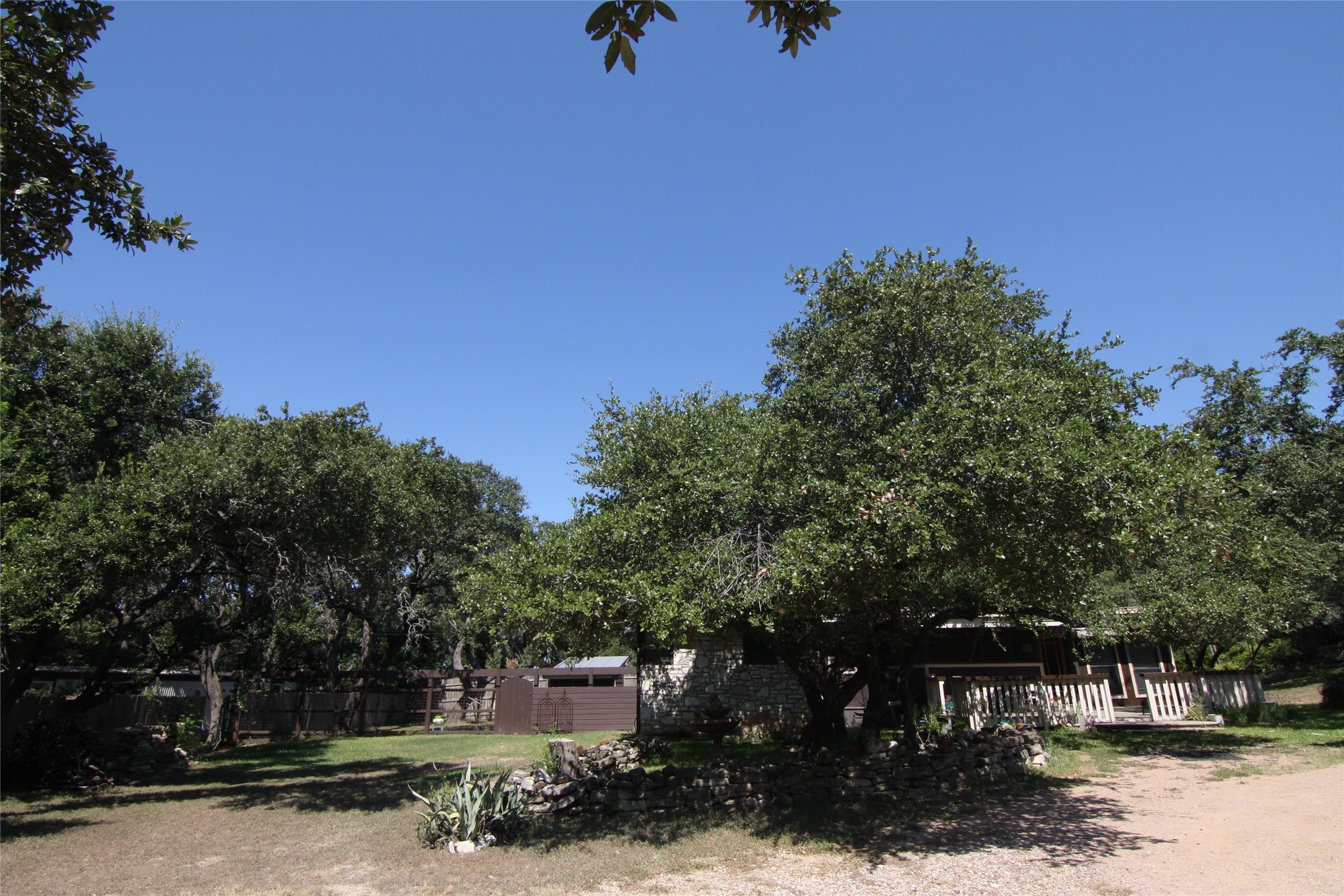 7806-7804 Indian Ridge Drive Austin, TX 78737 - Photo 40 of 40 a front view of a house with a yard