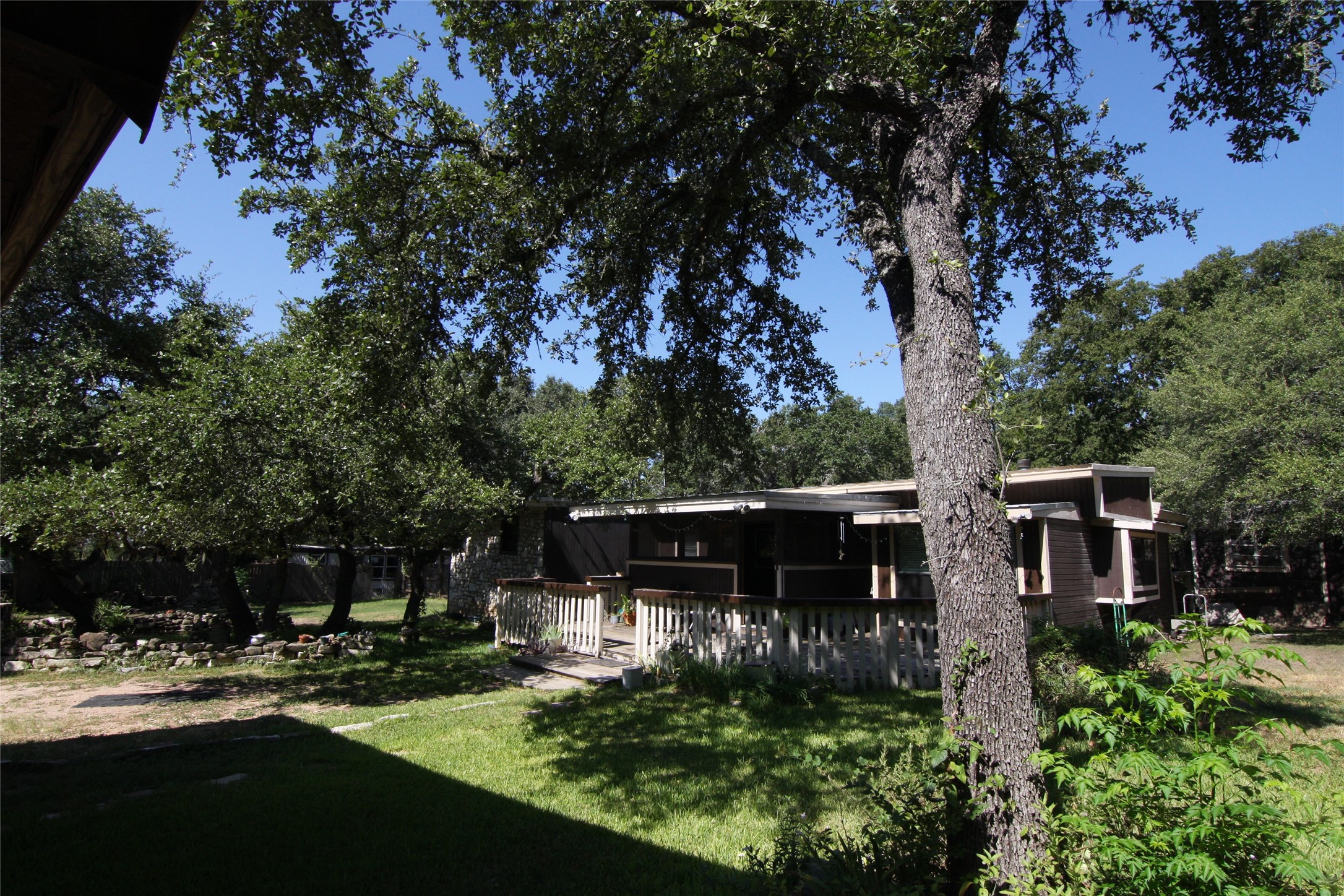 7806-7804 Indian Ridge Drive Austin, TX 78737 - Photo 9 of 40 a view of house with backyard outdoor seating and green space