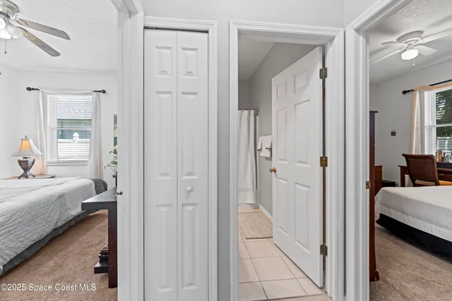 a view of a bedroom with a bed and glass door