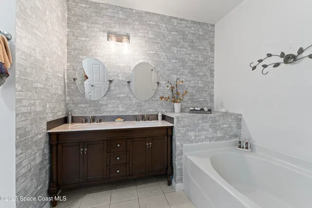 a bathroom with a tub sink and mirror