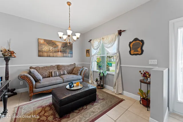 a living room with furniture flowerpot and window