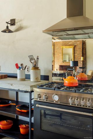 a stove top oven sitting inside of a kitchen