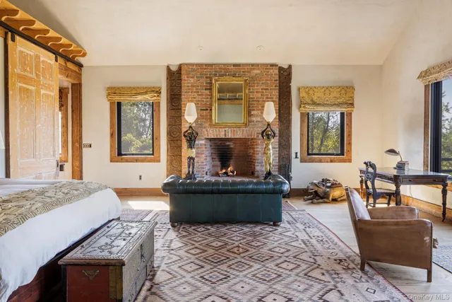 a spacious bedroom with a bed and wooden floor