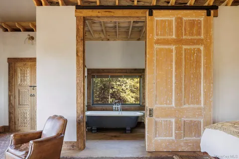 a living room with furniture a clock and a rug