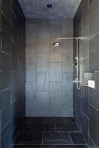 a living room with furniture a rug and a floor to ceiling window