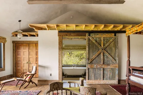 a bed sitting in a bedroom next to a window