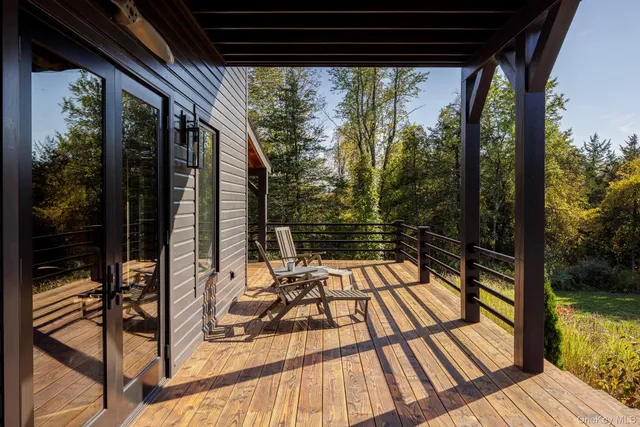 a view of balcony with wooden floor and outdoor seating
